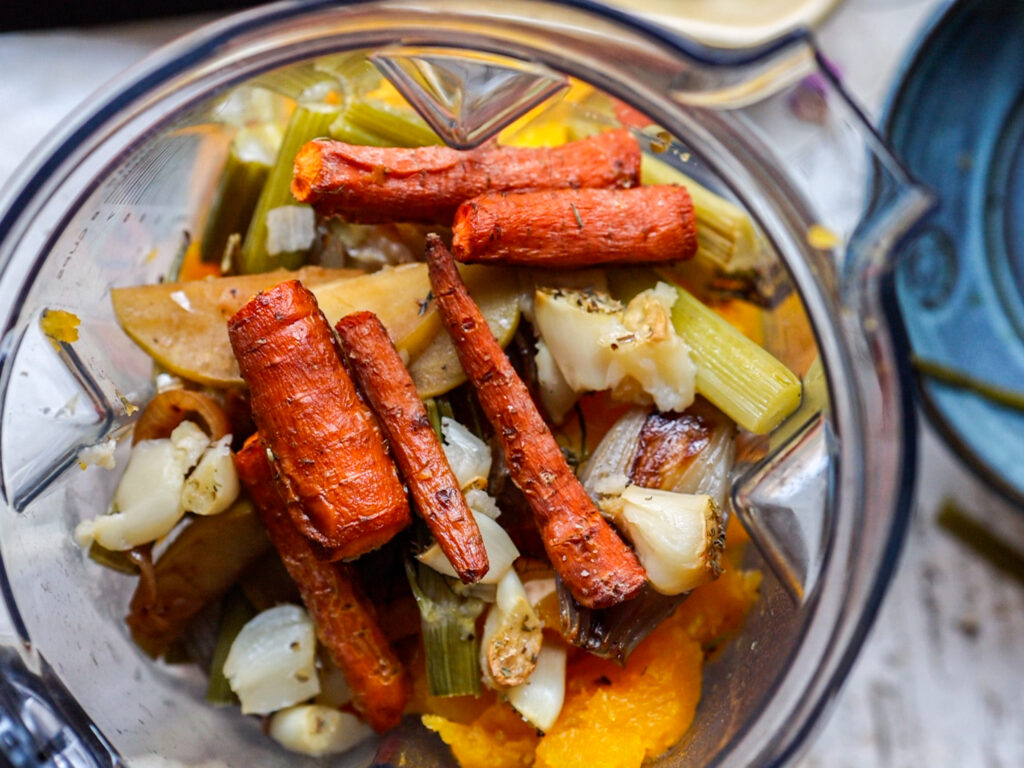 top down shot of blender with carrots on top